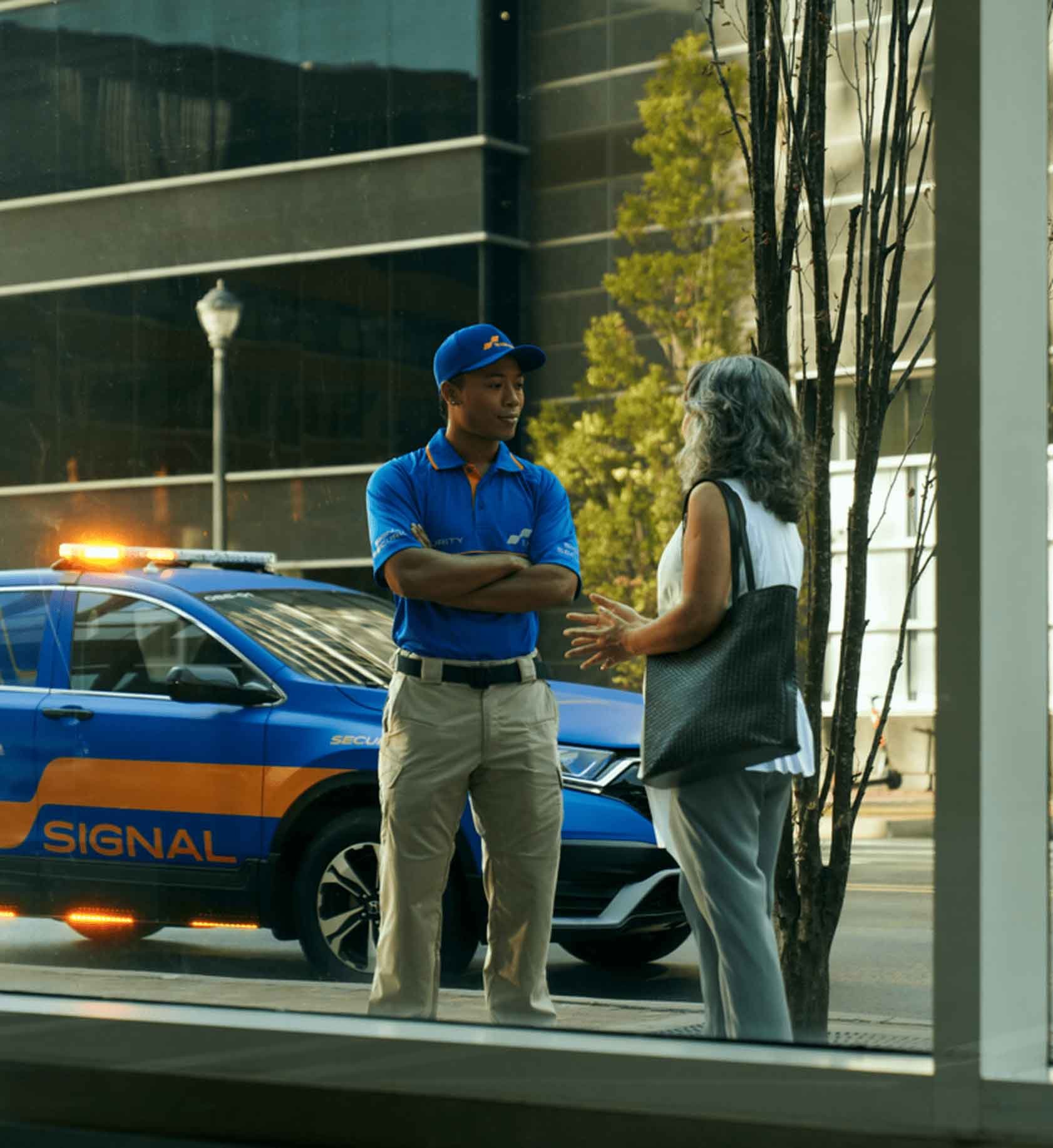 Signal employee talking to someone outside of a building