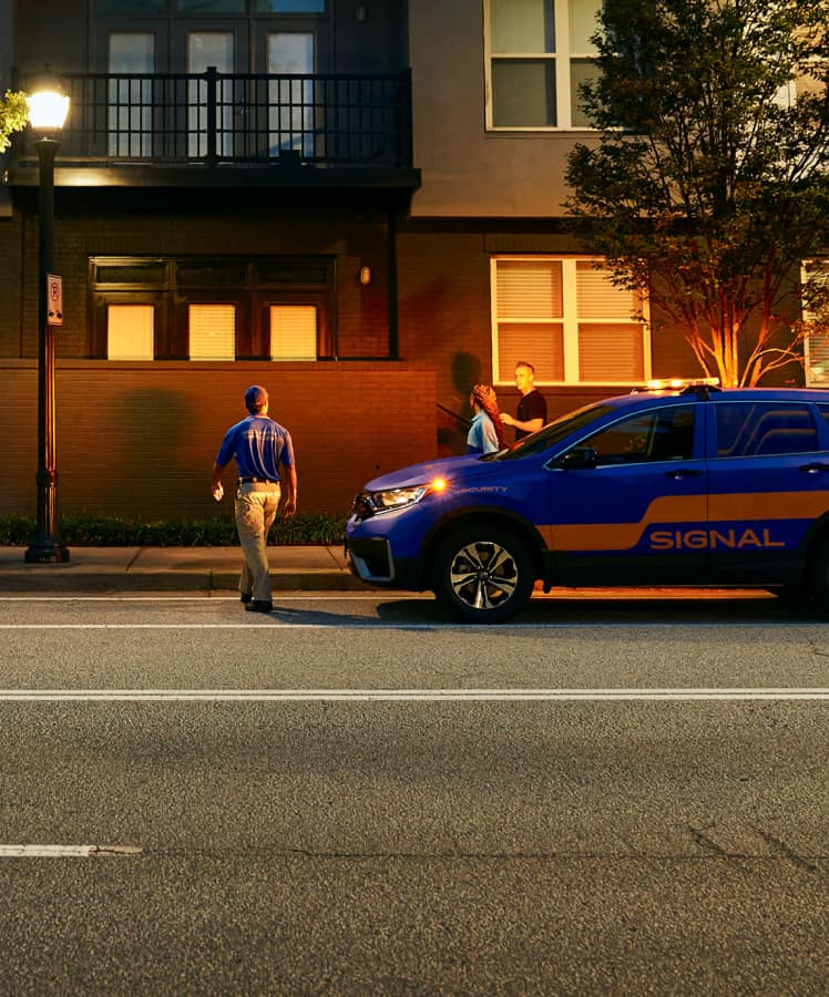 Signal employee walking in front of Signal company vehicle 
